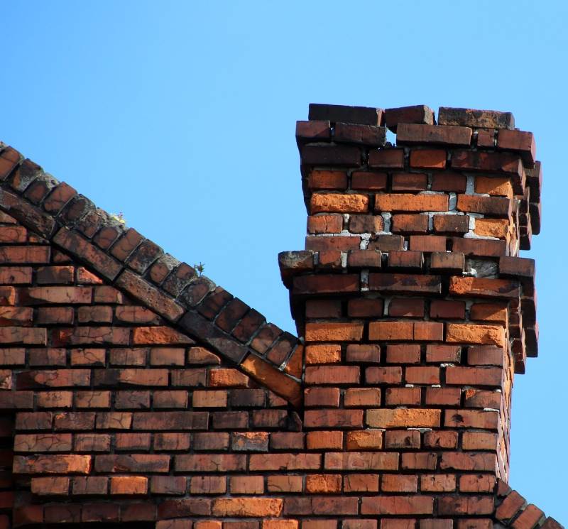 Damaged chimney on an Stoneham home showing cracks and missing mortar